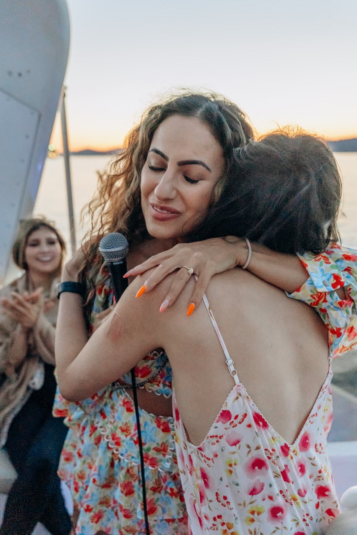 An embrace between two women at sunset