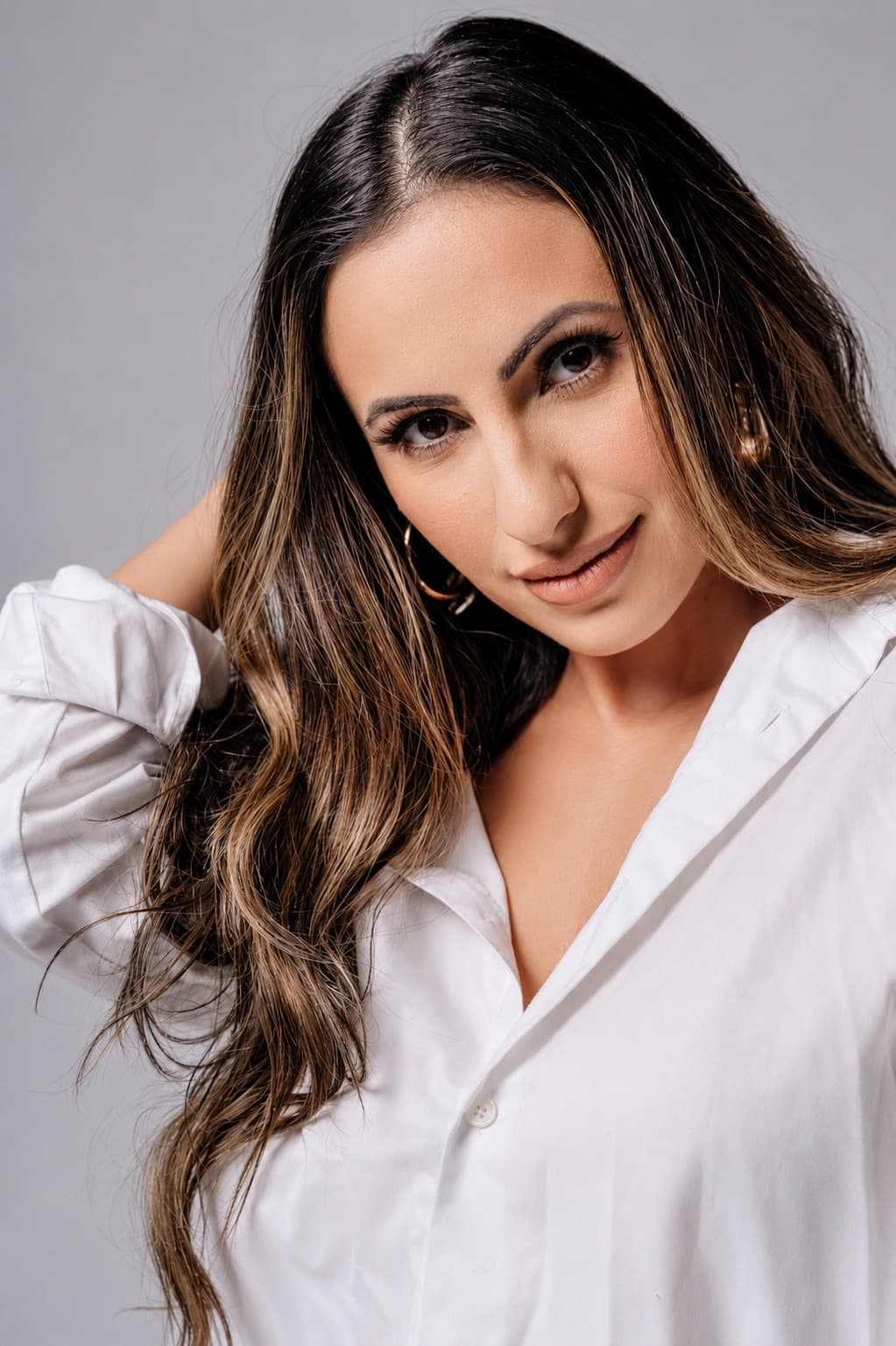 Hevi Serdar in a white shirt, eyes closed