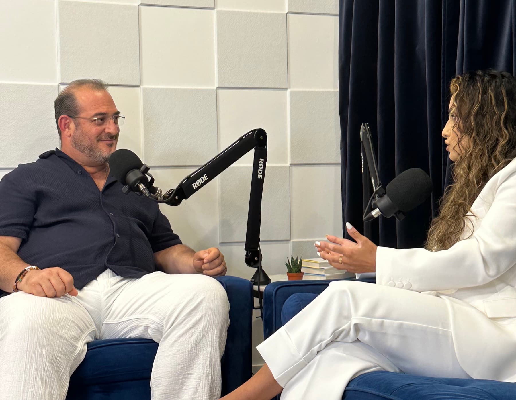 Hevi Serdar in conversation on a podcast set