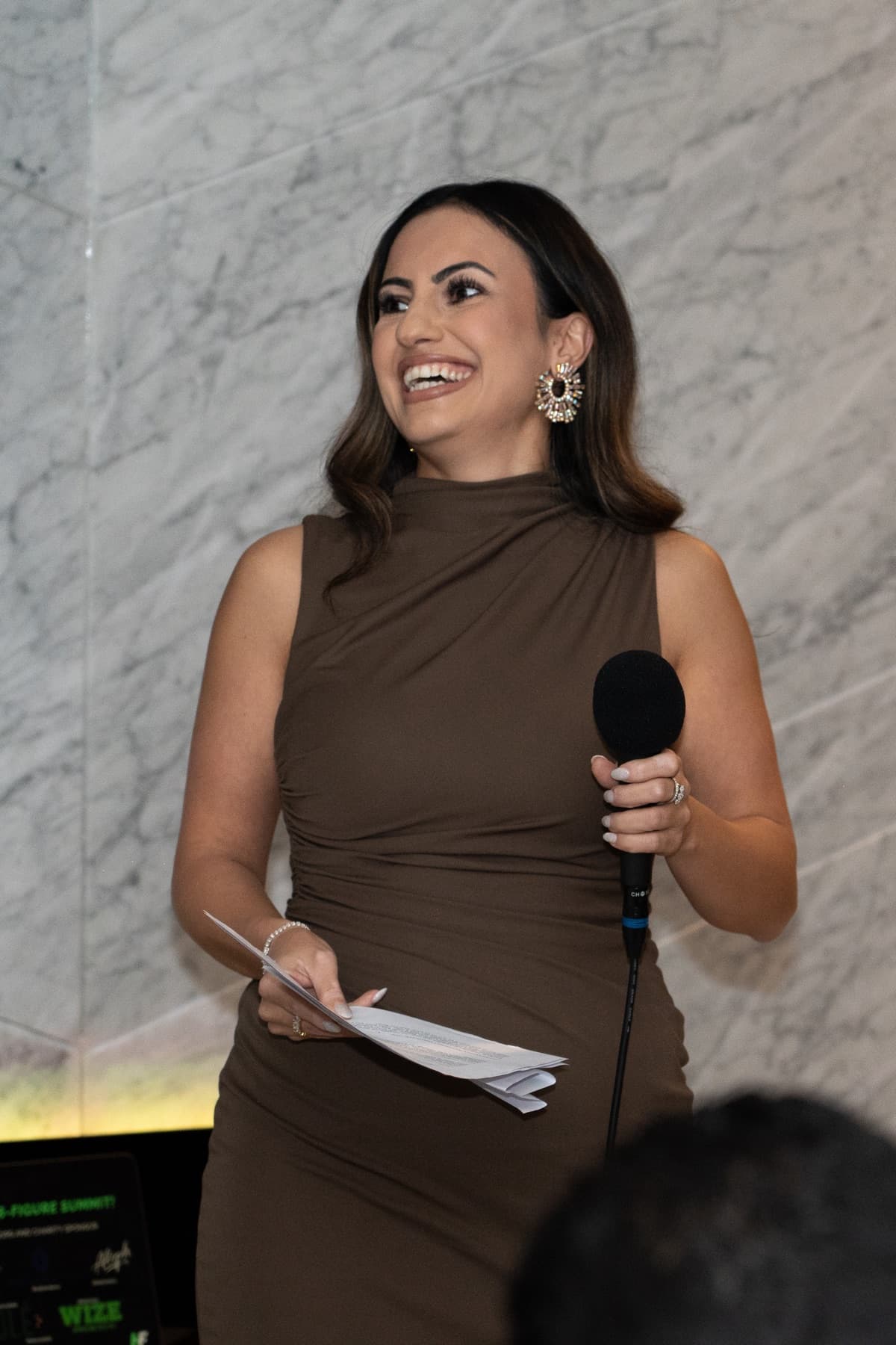 Hevi Serdar addressing a room from her notes