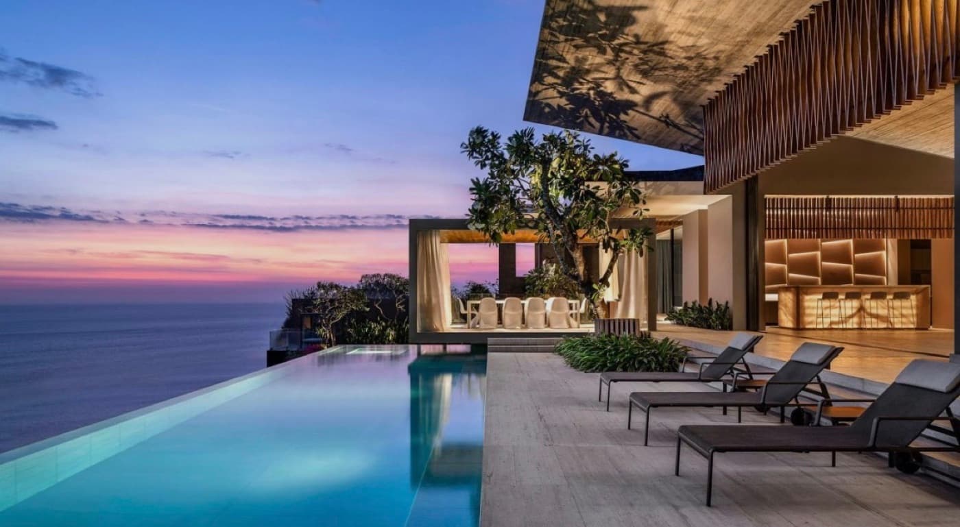 An infinity pool over the ocean at dusk in Bali